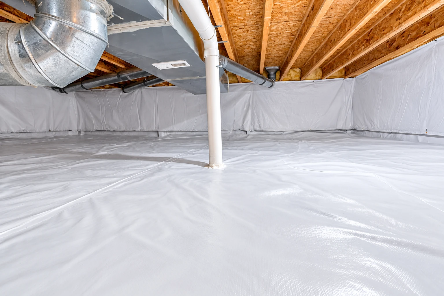White vapor barrier sheeting covers the floor and lower walls of a crawl space beneath exposed joists and ductwork.